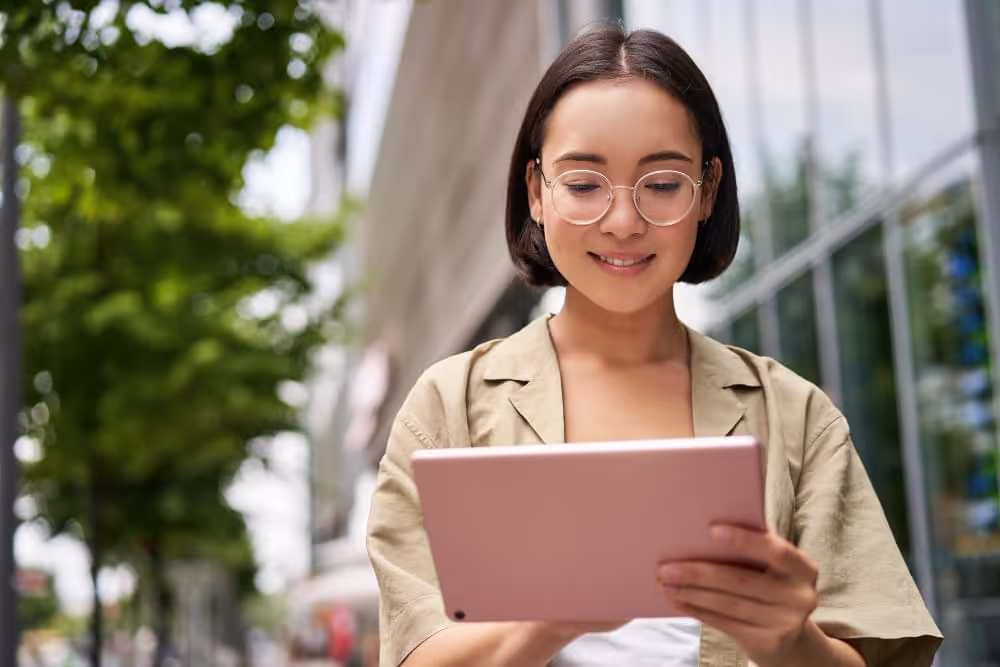 a short haired girl using her notepad happily